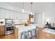 Modern kitchen featuring white cabinets, stainless steel appliances, and a center island with seating at 2640 Central Ct # 204, Denver, CO 80211