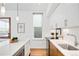 Well-lit kitchen with modern appliances, white cabinets, and a view from the window at 2640 Central Ct # 204, Denver, CO 80211