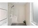 Contemporary bathroom shower featuring a glass enclosure and tiled walls at 2640 Central Ct # 204, Denver, CO 80211