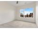 Bright bedroom featuring carpet, a ceiling fan, and a large window with beautiful views at 2876 W 53Rd Ave # 122, Denver, CO 80221