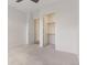 Spacious bedroom features neutral carpet, white trim, and an open closet with shelving at 2876 W 53Rd Ave # 122, Denver, CO 80221