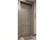 Gray apartment door with unit number 122 and modern handle hardware at 2876 W 53Rd Ave # 122, Denver, CO 80221