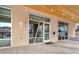 Building entrance with glass windows and doors, located near assigned parking spaces and a modern aesthetic at 2876 W 53Rd Ave # 122, Denver, CO 80221