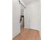 Hallway features wood flooring, a sliding barn door, and an access door to the home's water heater at 2876 W 53Rd Ave # 122, Denver, CO 80221