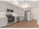 Modern kitchen equipped with stainless steel appliances, sleek cabinetry, and hardwood floors at 2876 W 53Rd Ave # 122, Denver, CO 80221