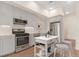 Bright kitchen features stainless steel appliances, light grey cabinetry, and a stylish kitchen island at 2876 W 53Rd Ave # 122, Denver, CO 80221