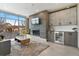 Inviting living room with fireplace, bar area, cabinets, and large windows at 2876 W 53Rd Ave # 122, Denver, CO 80221