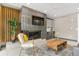 Stylish living room featuring a fireplace, decorative wood panel, and modern furnishings at 2876 W 53Rd Ave # 122, Denver, CO 80221