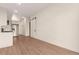 Open living area featuring hardwood floors and a sliding barn door at 2876 W 53Rd Ave # 122, Denver, CO 80221