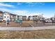 A community playground and exercise area is surrounded by modern townhomes under a blue sky at 2876 W 53Rd Ave # 122, Denver, CO 80221