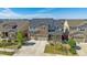 Expansive aerial view of a two-story home with stone accents, three-car garage, and well-maintained lawn at 14997 Elsinore Ave, Parker, CO 80134
