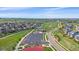 Gorgeous aerial view of the community with a pool, basketball court, and well-maintained green spaces at 14997 Elsinore Ave, Parker, CO 80134