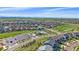 Serene aerial view showcases the neighborhood's landscape with green spaces, pool, and mountain views at 14997 Elsinore Ave, Parker, CO 80134