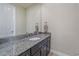 Bright bathroom featuring a granite countertop vanity with a large mirror at 14997 Elsinore Ave, Parker, CO 80134