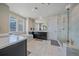 Luxurious bathroom with marble accents, a soaking tub, and a glass-enclosed shower at 14997 Elsinore Ave, Parker, CO 80134
