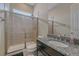 Bathroom featuring granite countertop vanity and tiled shower with glass doors at 14997 Elsinore Ave, Parker, CO 80134