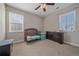 Bedroom with a crib, dresser, and lots of natural light from the two windows at 14997 Elsinore Ave, Parker, CO 80134
