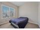 Simple bedroom featuring neutral walls, a large window, and a dark bed frame at 14997 Elsinore Ave, Parker, CO 80134