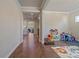 Inviting hallway with hardwood floors, crown molding, and views into other rooms at 14997 Elsinore Ave, Parker, CO 80134
