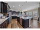 Modern kitchen with dark cabinets, stainless steel appliances, and a large center island at 14997 Elsinore Ave, Parker, CO 80134