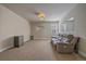 Carpeted living room featuring a gray couch, accent lights and two mirrors at 14997 Elsinore Ave, Parker, CO 80134