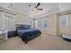 Cozy main bedroom with tray ceilings, neutral tones, and lots of natural light at 14997 Elsinore Ave, Parker, CO 80134