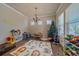Spacious playroom with hardwood floors, bright windows, and fun, colorful decor at 14997 Elsinore Ave, Parker, CO 80134