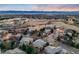 Aerial view showcasing a residential neighborhood nestled against a mountain range at sunset at 683 Ridgemont Cir, Highlands Ranch, CO 80126