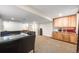 Finished basement area with kitchenette, dining table, and lounge area at 683 Ridgemont Cir, Highlands Ranch, CO 80126