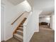Carpeted stairs lead to a finished basement with a comfortable seating area and neutral decor at 683 Ridgemont Cir, Highlands Ranch, CO 80126