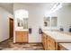Bright bathroom featuring dual sinks, tile countertops and wood-look floors at 683 Ridgemont Cir, Highlands Ranch, CO 80126