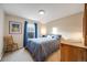 Comfortable bedroom with natural light from the window, complemented by calming decor at 683 Ridgemont Cir, Highlands Ranch, CO 80126