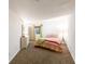 Bright bedroom with carpeting, features a light colored bed and green accents at 683 Ridgemont Cir, Highlands Ranch, CO 80126