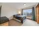Cozy bedroom with a neutral color palette, a large window, and comfortable furnishings at 683 Ridgemont Cir, Highlands Ranch, CO 80126