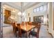 Elegant dining room with a large wooden table, chandelier, and open floor plan at 683 Ridgemont Cir, Highlands Ranch, CO 80126