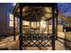 Cozy backyard gazebo features a table and chairs with string lighting perfect for outdoor dining at 683 Ridgemont Cir, Highlands Ranch, CO 80126
