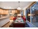 Eat-in kitchen boasts stainless steel appliances, island, and direct access to outdoor patio at 683 Ridgemont Cir, Highlands Ranch, CO 80126