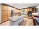 Gourmet kitchen boasts stainless steel appliances, a center island, and ample cabinet space at 683 Ridgemont Cir, Highlands Ranch, CO 80126