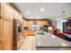 Spacious kitchen with stainless steel appliances, light wood cabinetry, and a granite-topped island at 683 Ridgemont Cir, Highlands Ranch, CO 80126