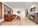 Cozy living room featuring hardwood floors, a fireplace, and large windows at 683 Ridgemont Cir, Highlands Ranch, CO 80126