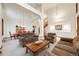 Open-concept living space with high ceilings, elegant staircase, and comfortable seating, ideal for entertaining guests at 683 Ridgemont Cir, Highlands Ranch, CO 80126