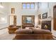 Bright living room features soaring ceilings, fireplace and large windows offering natural light at 683 Ridgemont Cir, Highlands Ranch, CO 80126