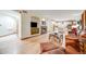 Open concept living room leading to kitchen, features a fireplace and bright hardwood floors at 683 Ridgemont Cir, Highlands Ranch, CO 80126