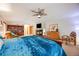 Cozy main bedroom with a fireplace, large bed, and ample natural light at 683 Ridgemont Cir, Highlands Ranch, CO 80126