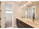 Bright bathroom featuring double sink vanity with white countertops and modern lighting fixtures at 5926 Hickory Oaks Trl, Castle Rock, CO 80104