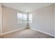 Cozy bedroom featuring carpeted floors and natural light from large windows at 5926 Hickory Oaks Trl, Castle Rock, CO 80104