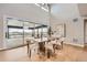 Bright dining area with floor-to-ceiling windows, hardwood floors, and a modern table setting at 5926 Hickory Oaks Trl, Castle Rock, CO 80104
