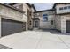 Modern home featuring a sleek garage door, stone facade, and contemporary architectural details at 5926 Hickory Oaks Trl, Castle Rock, CO 80104