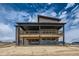 Exterior of home featuring covered deck, stone accents and modern design at 5926 Hickory Oaks Trl, Castle Rock, CO 80104
