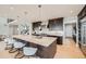 Modern kitchen with a large center island, stainless steel appliances, and bar stool seating at 5926 Hickory Oaks Trl, Castle Rock, CO 80104